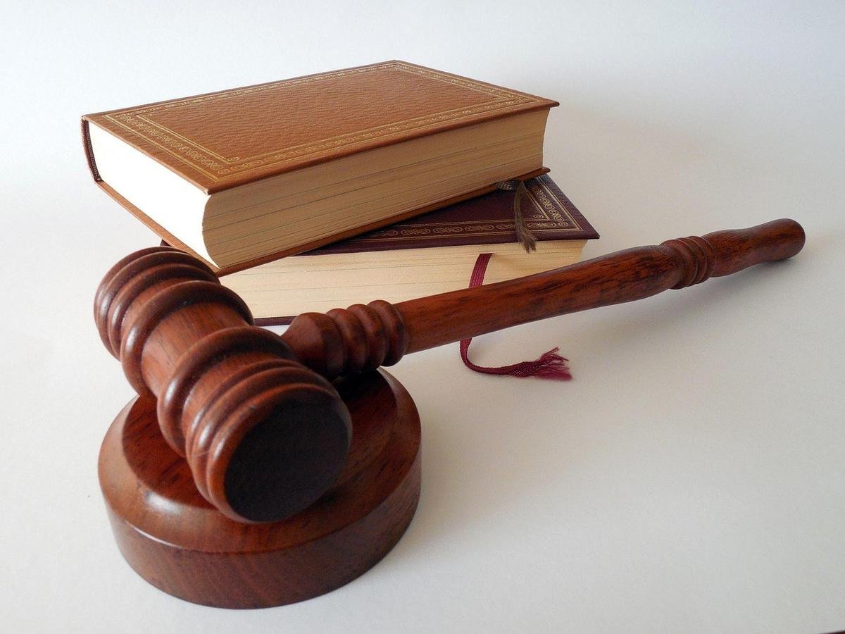 Marteau de justice sur socle, livre ouvert, livre fermé