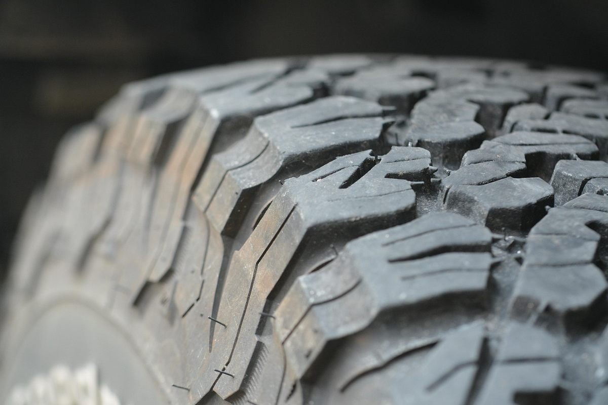 Tire tread pattern close-up showing rugged rubber blocks and grooves